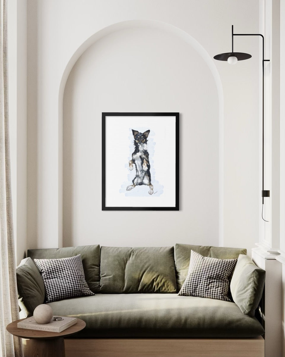 Framed pet portrait of Bruno in a black frame, hung on a living room wall.