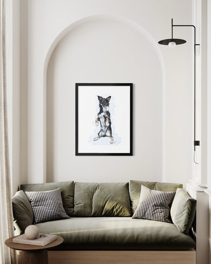 Framed pet portrait of Bruno in a black frame, hung on a living room wall.