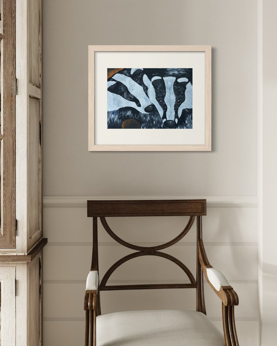 Natural wood A2 badger art print on a pale grey hallway wall with white panelled wainscoting beside a walnut Regency armchair in cream.