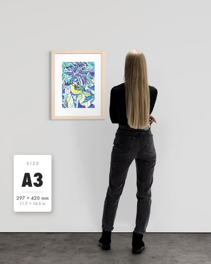 Andrea Nicole 'Taking Flight' blue tit art print in a natural wood A3 frame shown to scale beside a standing woman on a gallery wall, with an A3 (297 × 420 mm) size label. | an:family=print;role=sizeref;size=A3;finish=natural