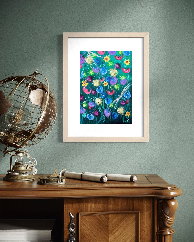 Natural wood A4 wildflower art print on a sage green wall above an antique walnut writing bureau with a brass armillary globe and old scrolls.