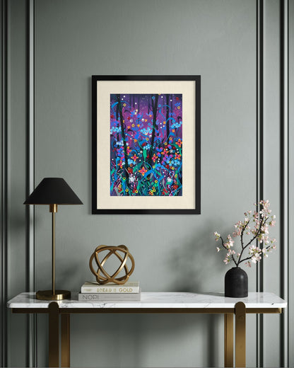 Black framed A2 wildflower art print on a sage panelled wall above a marble console with a brass lamp, cookbooks and cherry blossom.