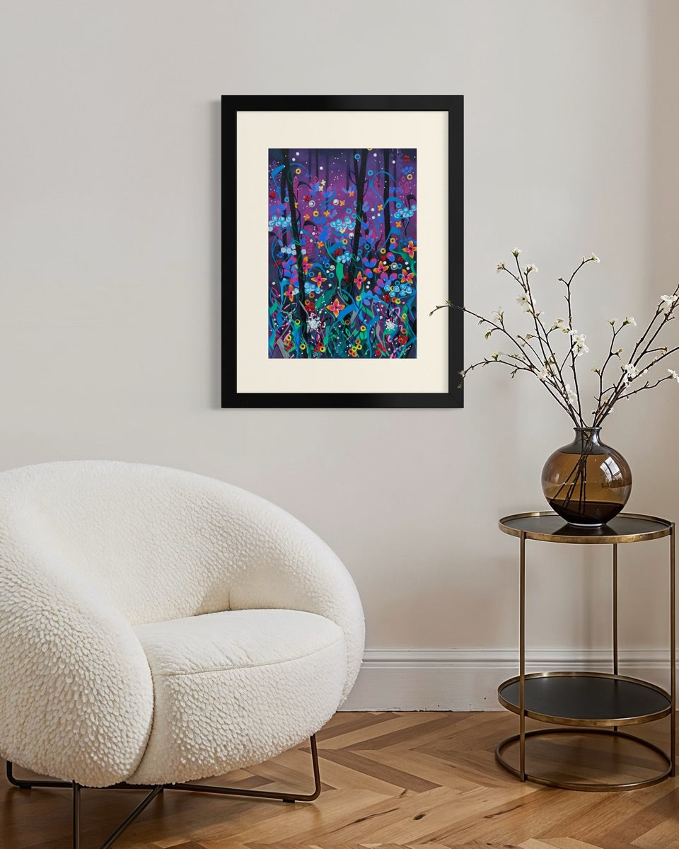 Black framed A3 twilight floral painting on a pale grey wall above a white bouclé chair and brass side table with blossom in a smoke orb.