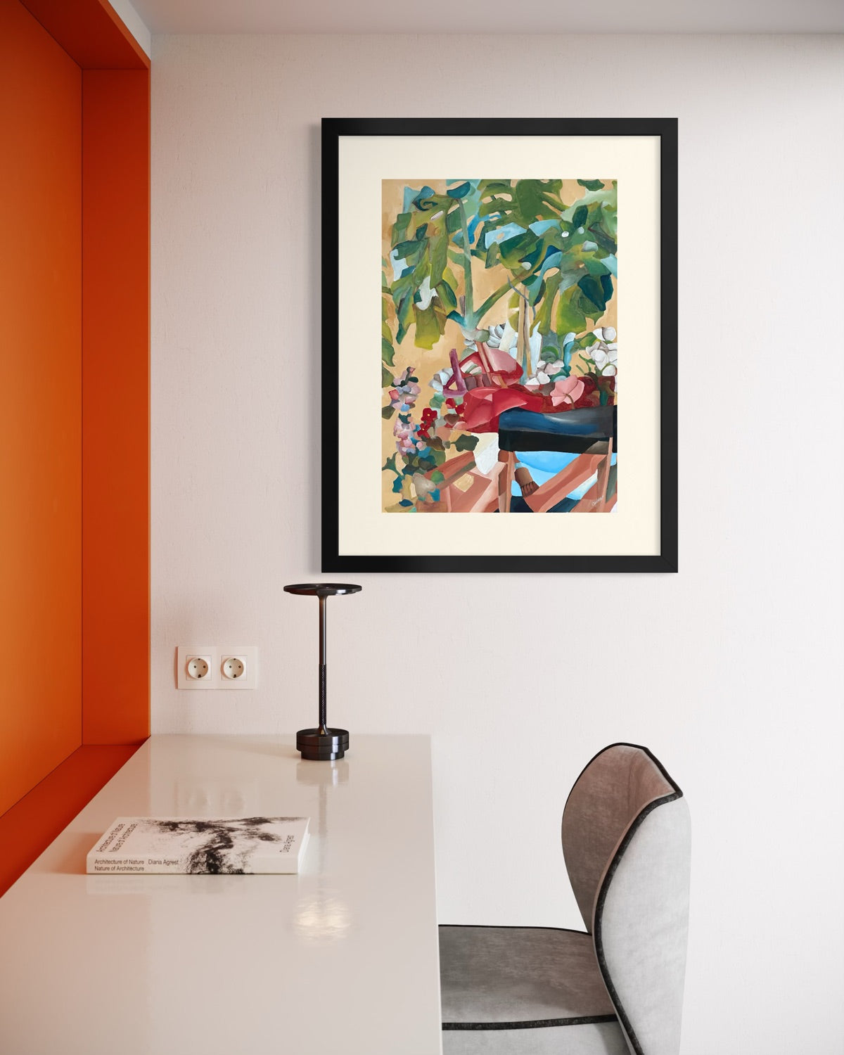 Black framed A2 garden painting on a white wall in a minimalist study with a burnt orange alcove, slim task lamp and grey velvet chair.