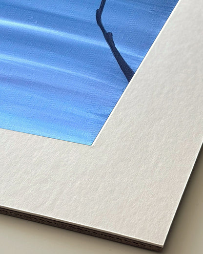 Andrea Nicole 'Patience' giclée fine art print in an off-white window mount, shown corner-on so the bevel-cut window opening, 100% cotton paper and mount board are visible. | an:family=print;role=mount