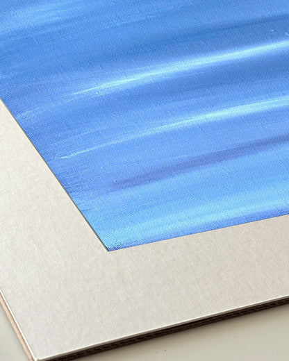 Andrea Nicole 'Patience' giclée fine art print in an off-white window mount, shown corner-on so the bevel-cut window opening, 100% cotton paper and mount board are visible. | an:family=print;role=mount