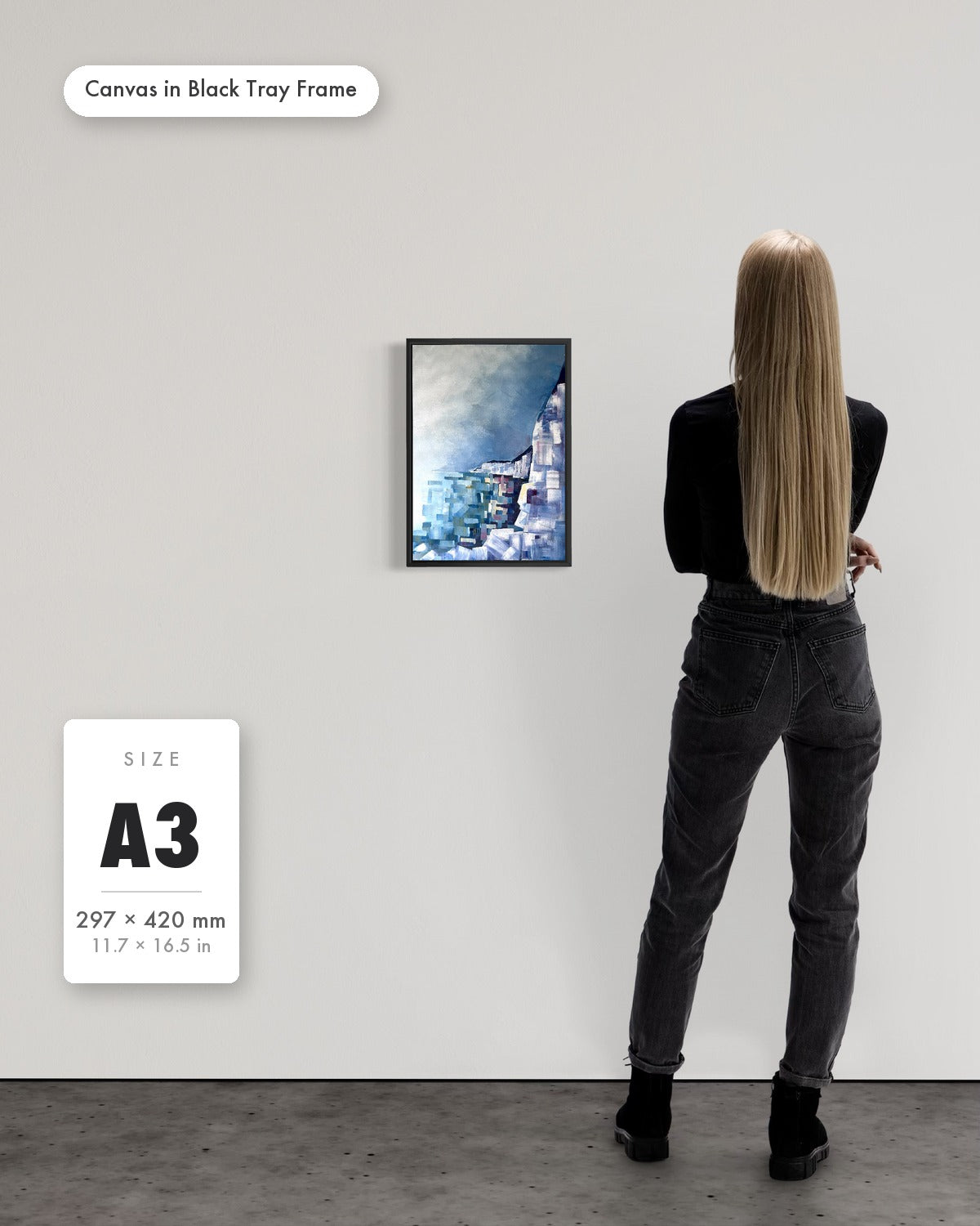 Andrea Nicole 'Solitude' fine art canvas in a black tray float frame, A3 — shown to scale on a gallery wall with a size guide card. | an:family=canvas;role=sizeref;size=A3;finish=black