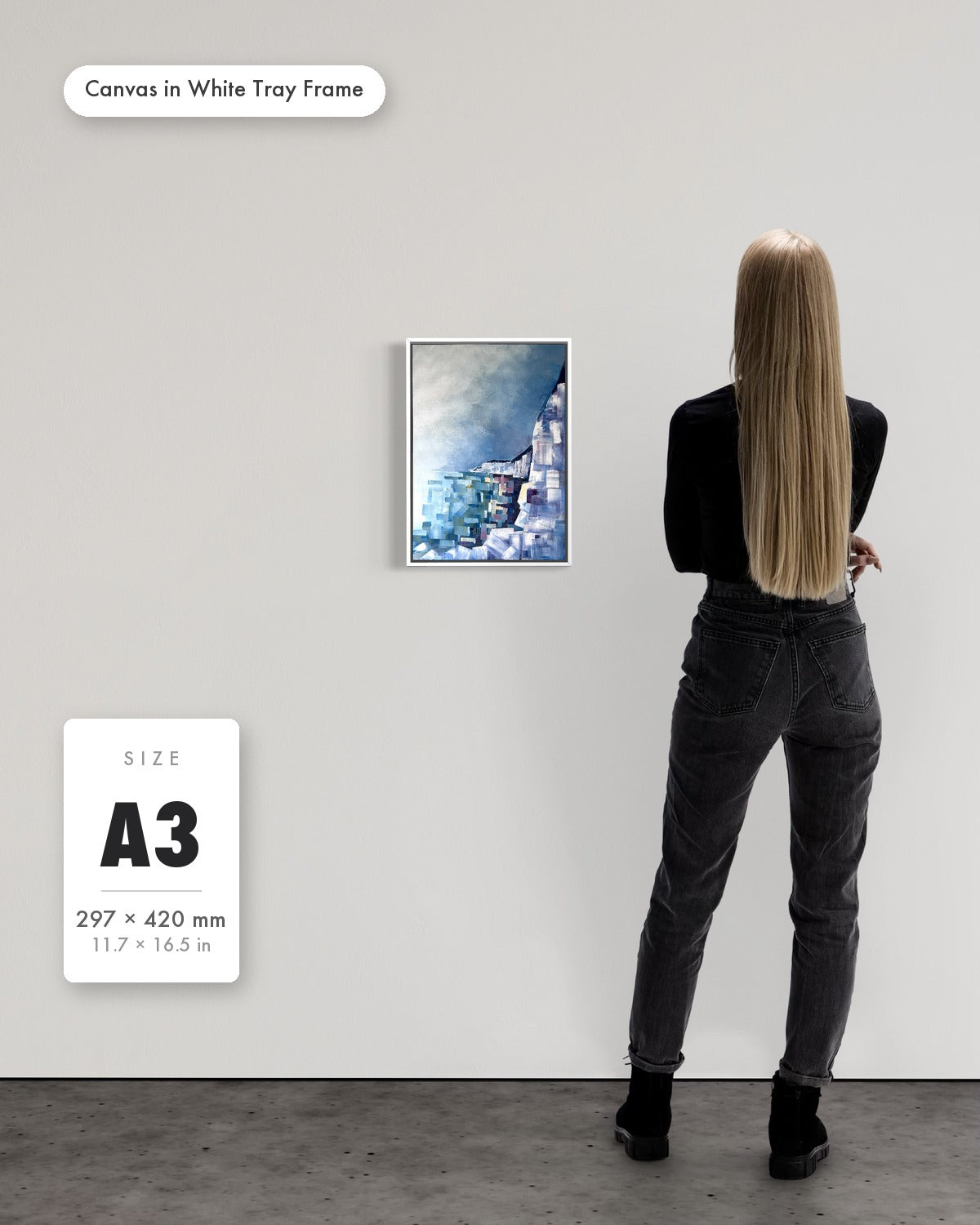 Andrea Nicole 'Solitude' fine art canvas in a white tray float frame, A3 — shown to scale on a gallery wall with a size guide card. | an:family=canvas;role=sizeref;size=A3;finish=white