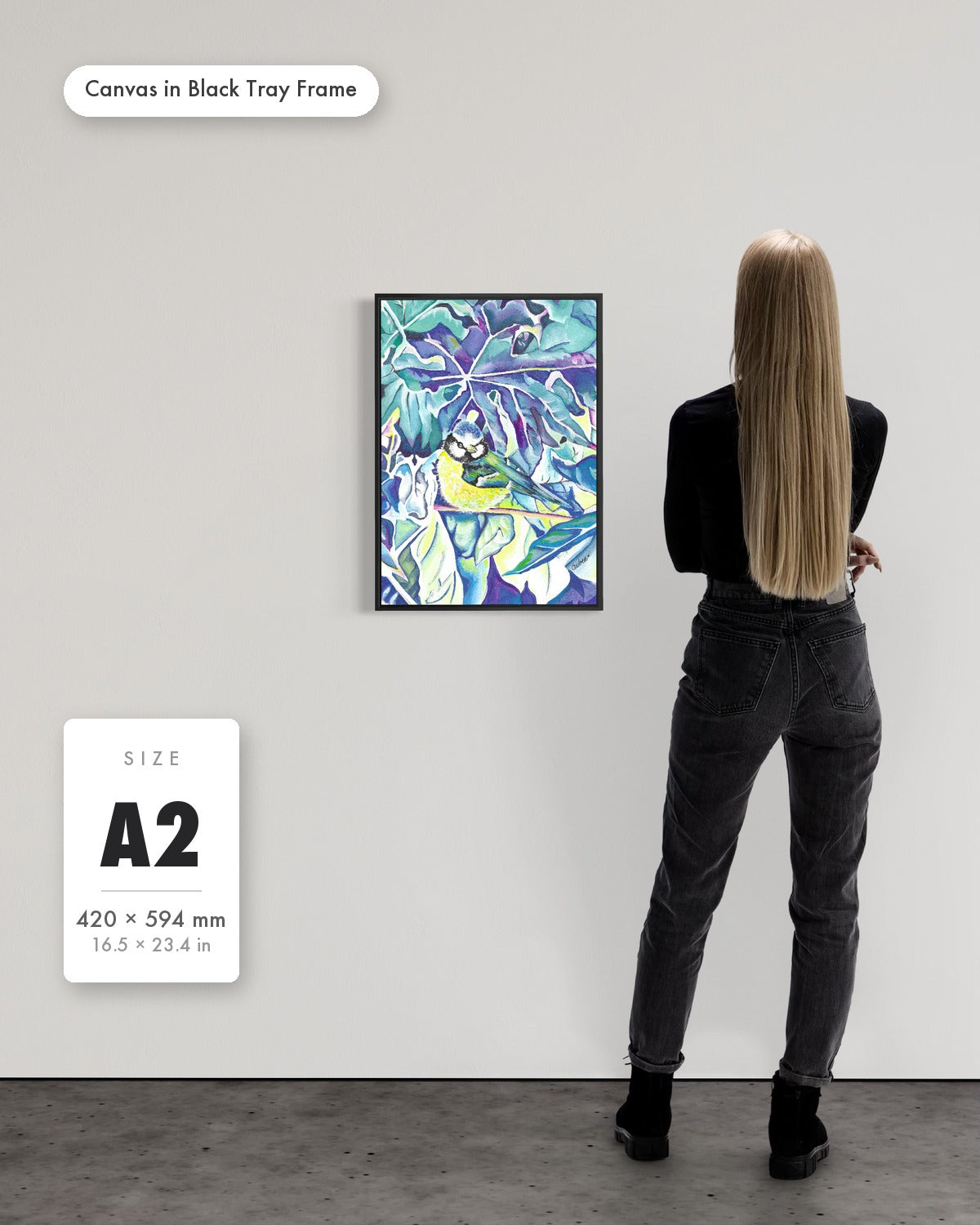 Andrea Nicole 'Taking Flight' fine art canvas in a black tray float frame, A2 — shown to scale on a gallery wall with a size guide card. | an:family=canvas;role=sizeref;size=A2;finish=black