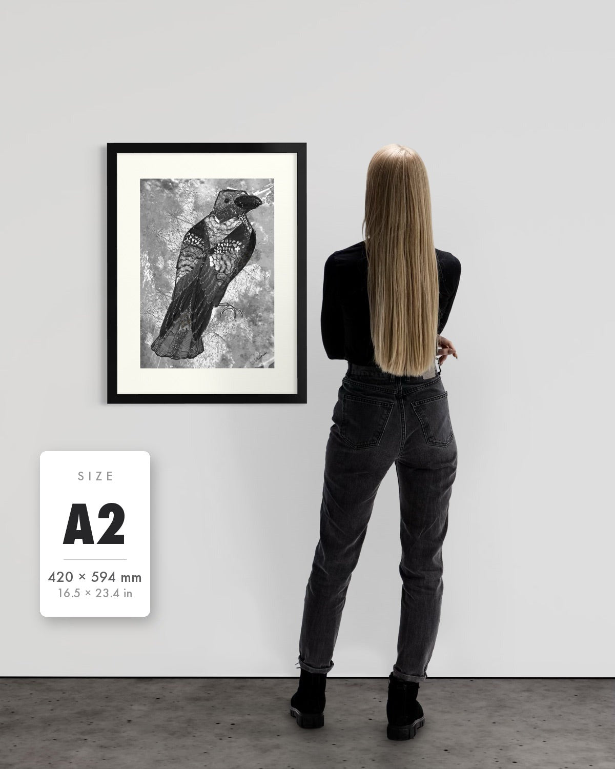 The Journey to Transformation — A2 (420 x 594 mm) black frame art print shown to scale beside a person, with a size guide card. | an:family=print;role=sizeref;size=A2;finish=black