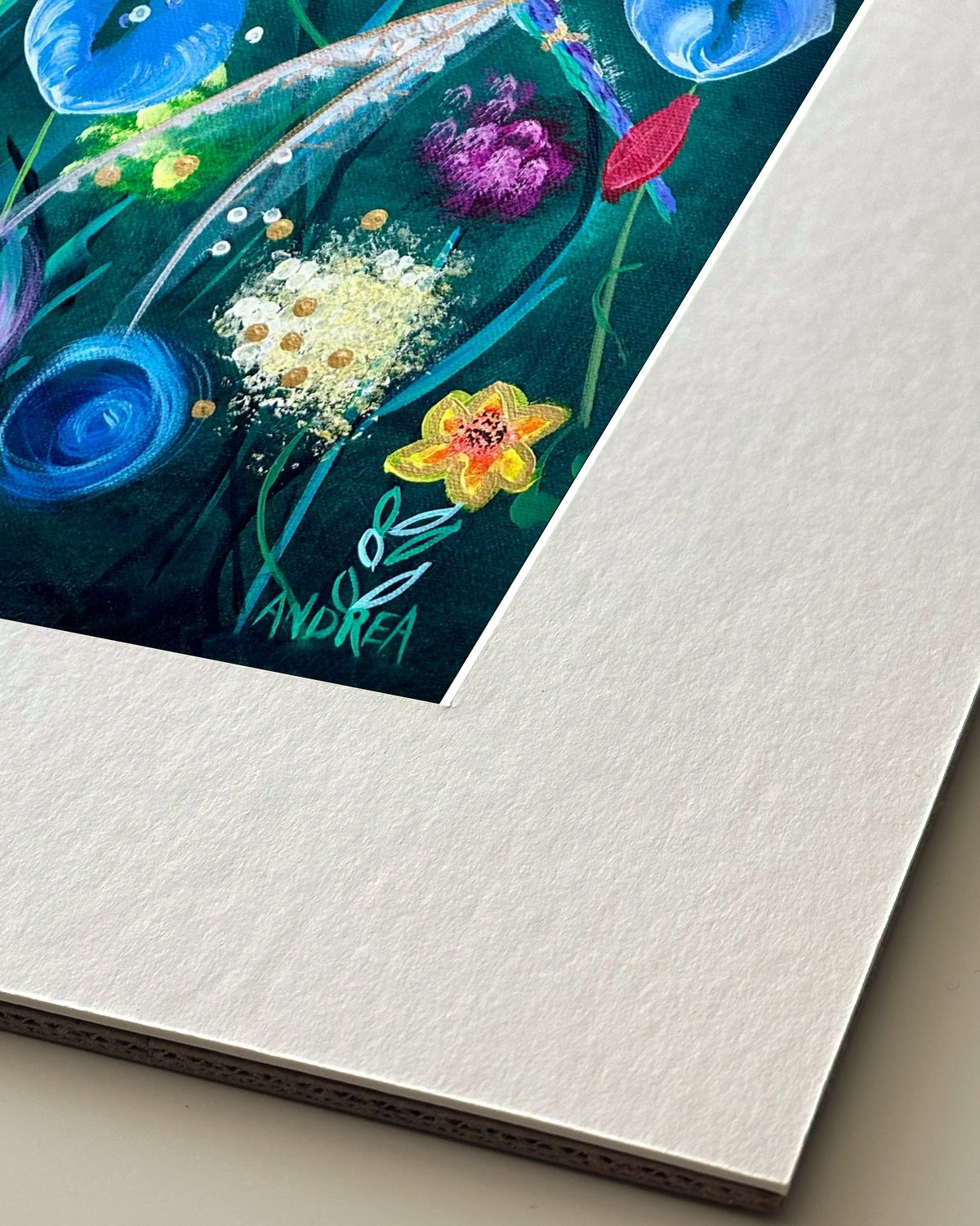 Andrea Nicole 'Things Still Bloomed' giclée fine art print in an off-white window mount, shown corner-on so the bevel-cut window opening, 100% cotton paper and mount board are visible. | an:family=print;role=mount
